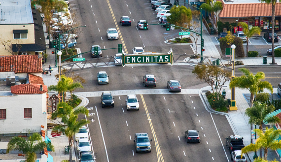 Aerial view of Downtown Encinitas with traffic under landmark 
