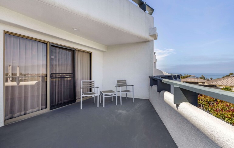 Private balcony with two chairs and side table