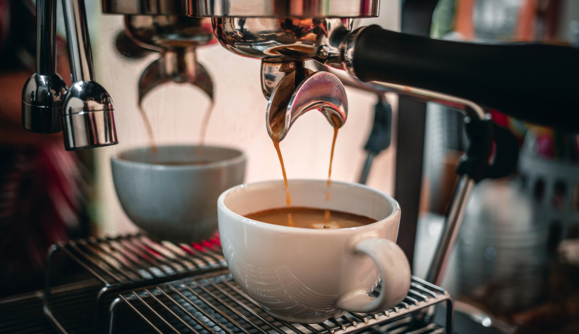 Close-up of espresso pouring from a coffee machine into a coffee cup